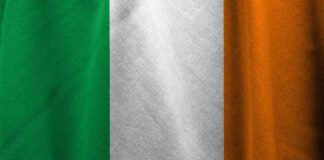 Flagga med tre vertikala ränder: grön till vänster, vit i mitten och orange till höger.