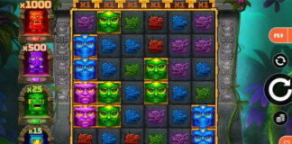 Slotspel med färgglada masker och symboler i djungeltema, vinstmultiplikatorer visas till vänster på spelskärmen.