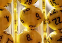 Man i 60-årsåldern vinner stort på Eurojackpot Gula lotteribollar med svarta siffror i genomskinliga rör, redo för dragning i Eurojackpot.