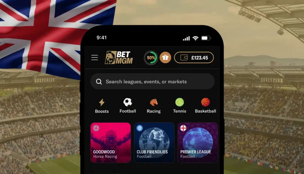 BetMGM:s sportsbook i en mobil framför brittisk flagga och fotbollsarena