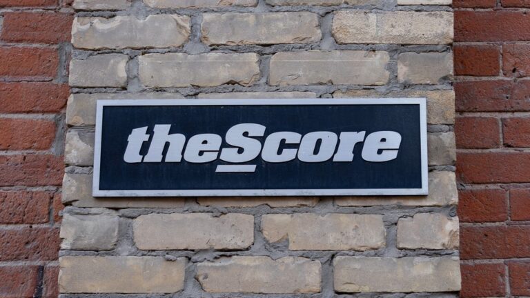 theScore logo mounted on a brick wall outside the company’s office