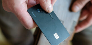 TransUnion unveils banking solution that promotes responsible gambling Hand holds bank card