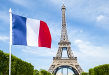 French flag in front of Eiffel Tower