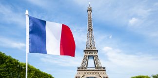 French flag in front of Eiffel Tower