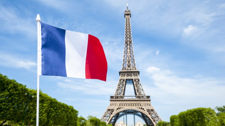 French flag in front of Eiffel Tower