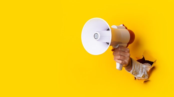 Hand holds megaphone