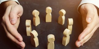 Hands surround wooden blocks