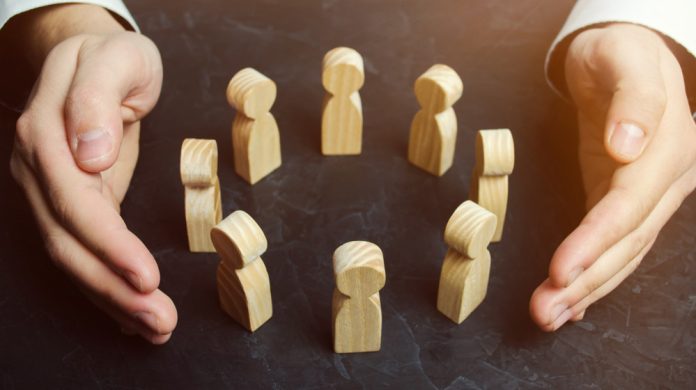 Hands surround wooden blocks