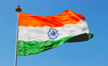 Indian Village Decides Anyone Who Gambles Illegally Will Be Publicly Slapped Flag of India waving in the wind