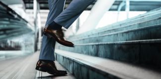 Motivation and challenging Concept. Steps Forward into a Success. Low Section of Businessman Walking Up on Staircase.