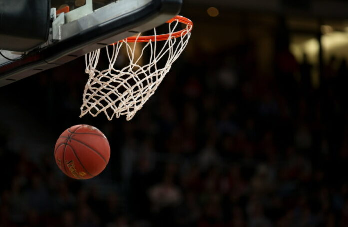 Basketball going through hoop and net