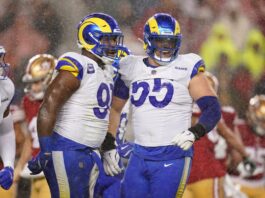 LA's Kobie Turner (91) is congratulated by defensive tackle Braden Fiske (55).