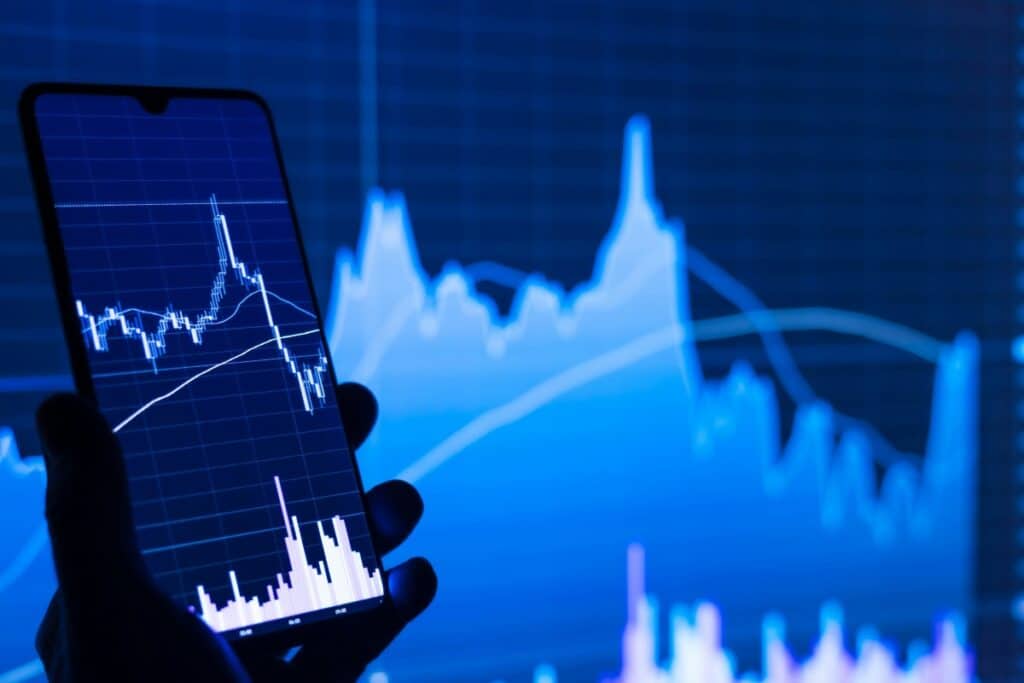 stock charts showing on a mobile phone and screen