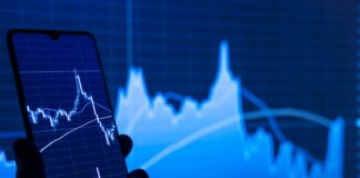 stock charts showing on a mobile phone and screen