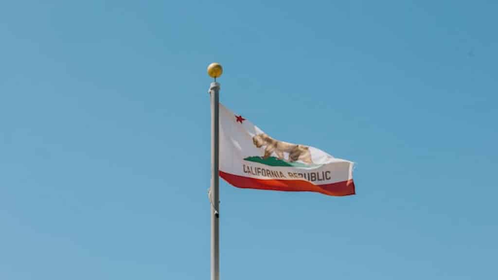 California flag flying in the wind on top of a building