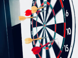 Several darts have missed the target on a dartboard