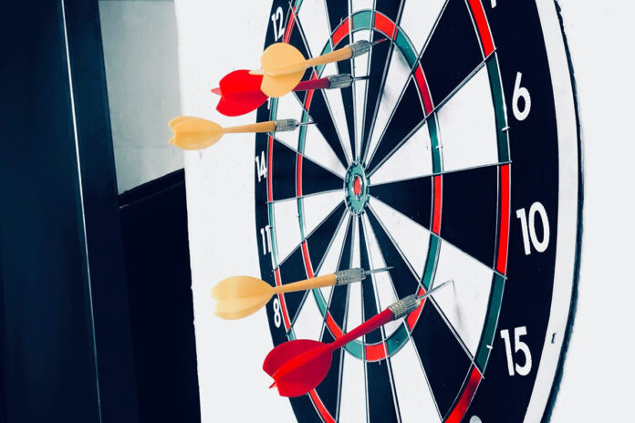 Several darts have missed the target on a dartboard