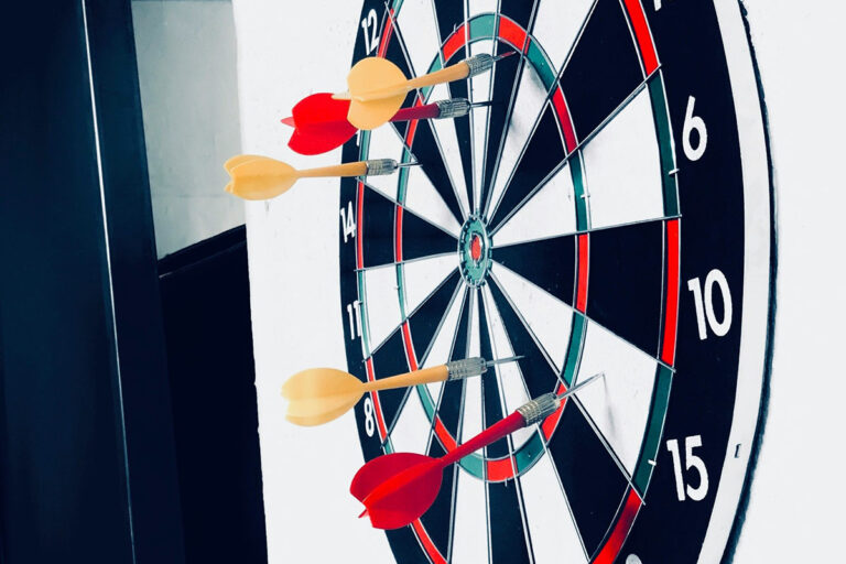 Several darts have missed the target on a dartboard