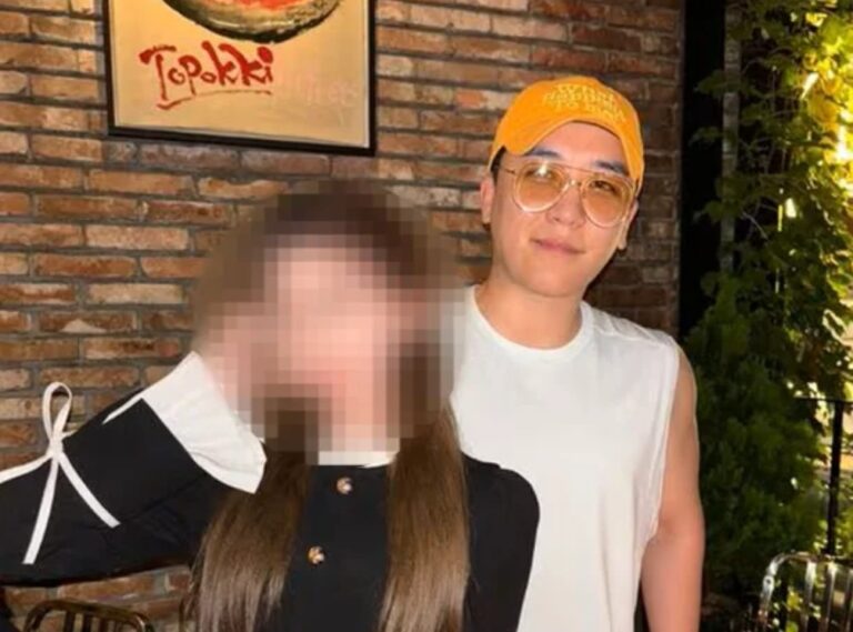 Seungri standing behind a female influencer in a social media post shared on Instagram.