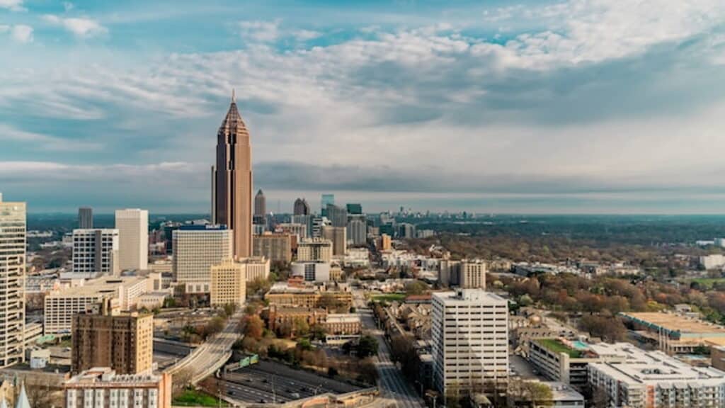 Aerial view of downtown Atlanta, Georgia, with high-rise buildings under a partly cloudy sky.