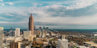 Aerial view of downtown Atlanta, Georgia, with high-rise buildings under a partly cloudy sky.