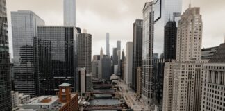 Chicago Weighs Municipal Tax on Online Sportsbooks as Budget Pressures Mount Aerial view of downtown Chicago with skyscrapers and river bridges on a cloudy day.