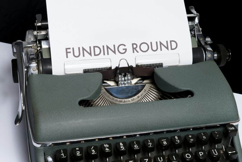 Typewriter with Funding Round written