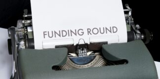 Typewriter with Funding Round written
