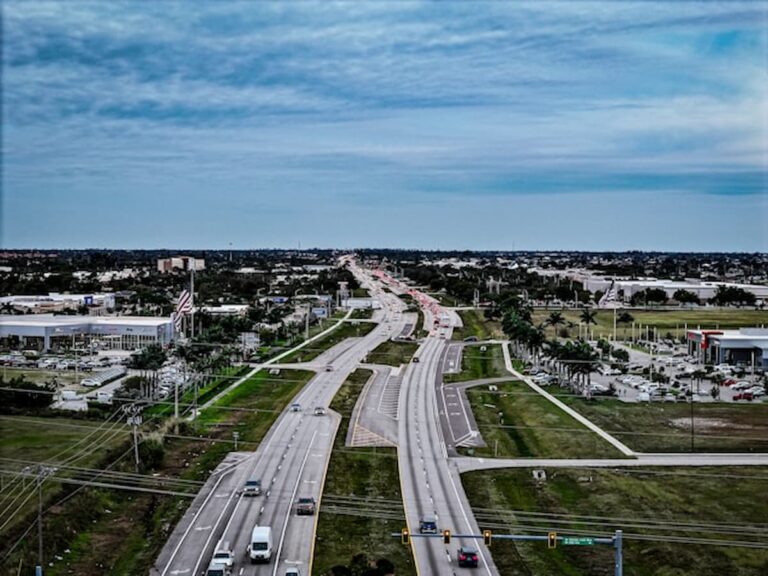 Aerial view of a Cape Coral highway surrounded by businesses and neighborhoods in Florida.