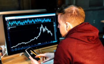 Man sitting at a desk looking at charts.