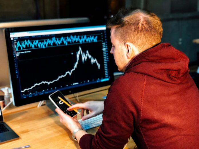 Man sitting at a desk looking at charts.