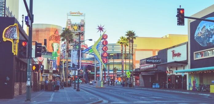 Downtown Las Vegas street view with neon signs and palm trees