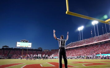 Louisiana vs. Delaware Odds & Best Bets for Tonight’s 68 Ventures Bowl Football referee signaling touchdown in stadium during game