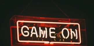 Neon sign displaying "Game On" in red against a dark background