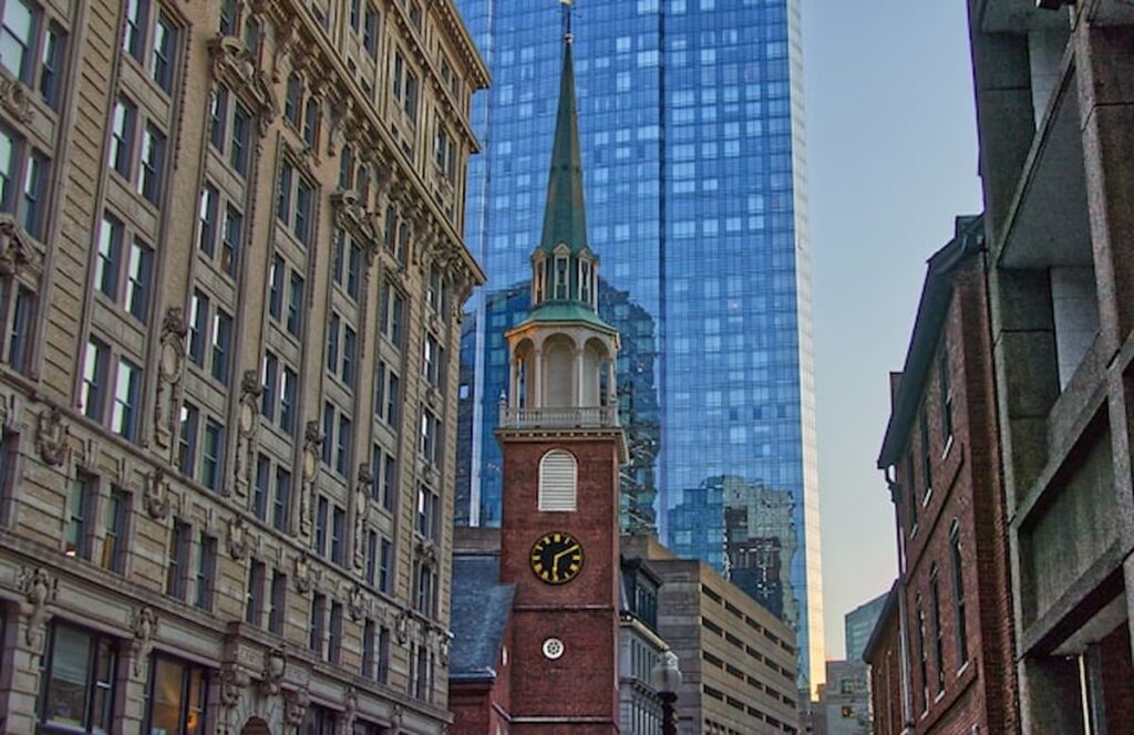 Historic brick meeting house with clock tower in city center.