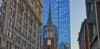 Historic brick meeting house with clock tower in city center.