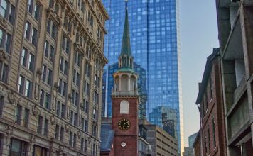 Boston Lawyer Sent to Prison for Embezzling $2M to Fuel Gambling Addiction Historic brick meeting house with clock tower in city center.