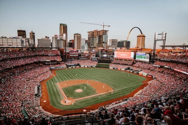 Full baseball stadium with downtown St. Louis skyline and Gateway Arch in the background.