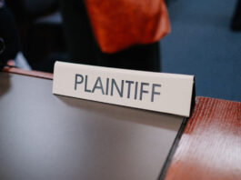 Courtroom sign reading “Plaintiff” on a desk