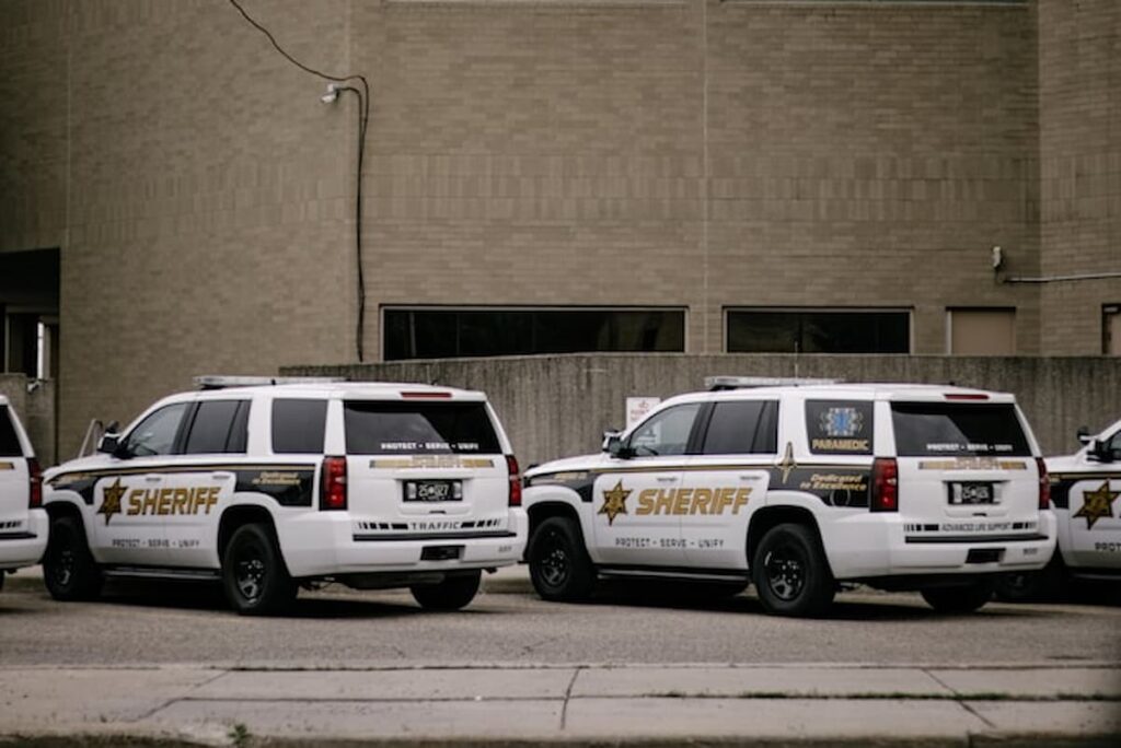 Sheriff vehicles parked outside a county building