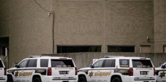 Sheriff vehicles parked outside a county building