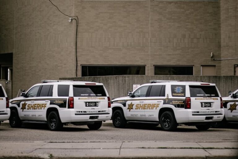 Sheriff vehicles parked outside a county building