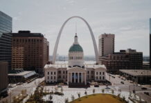 Downtown St. Louis skyline with Gateway Arch and historic courthouse building in the foreground.