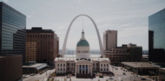 Downtown St. Louis skyline with Gateway Arch and historic courthouse building in the foreground.