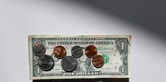 The Clearing Company Raises $15M Seed Round as Prediction Markets Accelerate in the U.S. A U.S. dollar bill with coins placed on top.