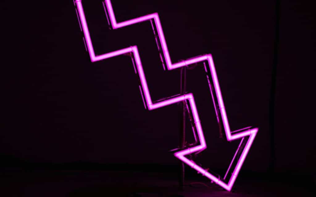 Downward pink neon arrow.