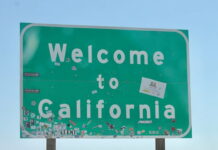 Sweepstakes Sportsbook Thrillzz Sued in California for Violating Sports Betting Laws Green roadside "Welcome to California" sign with stickers.