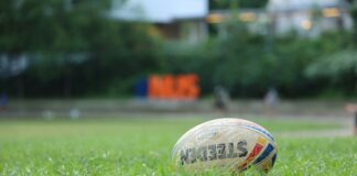 Rugby ball sitting in green grass