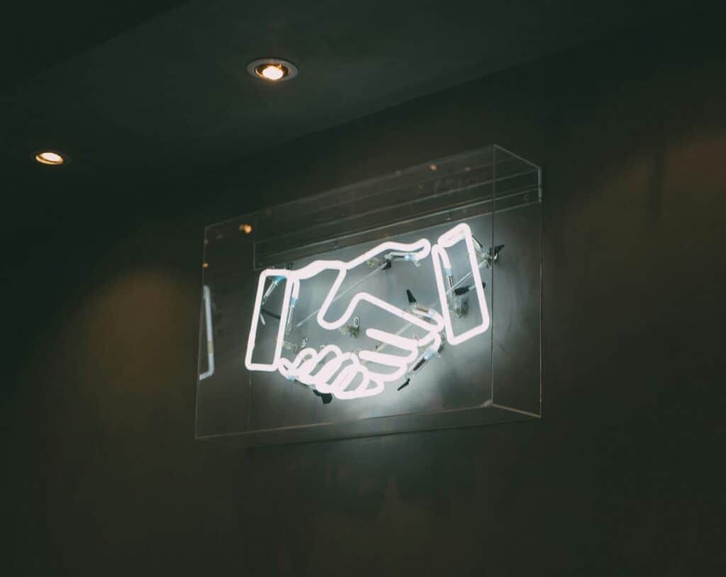 Neon sign of a handshake