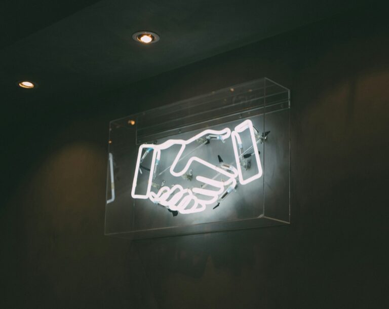 Neon sign of a handshake